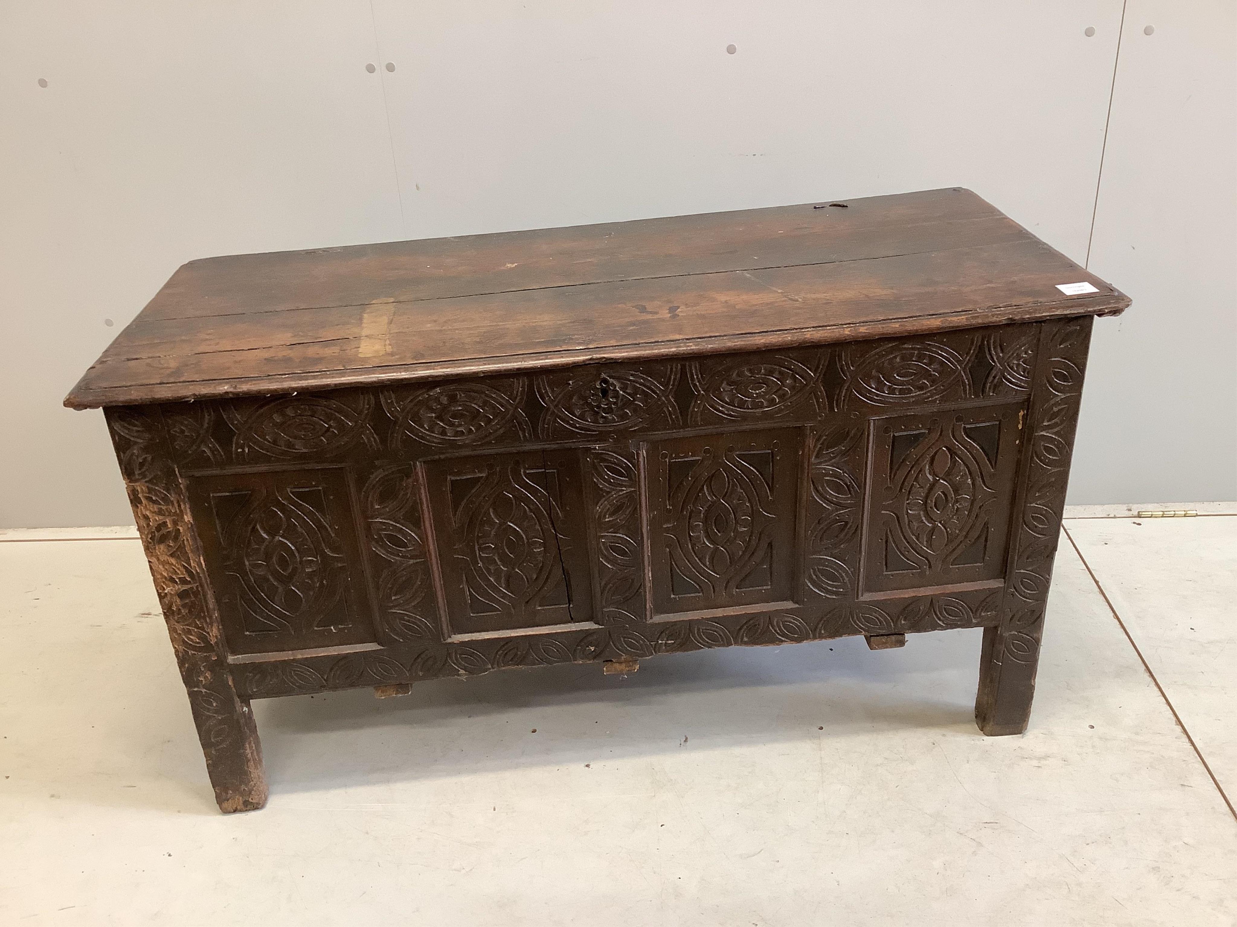 An 18th century carved oak coffer, width 125cm, depth 53cm, height 68cm. Condition - poor